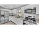Modern kitchen with white cabinets, stainless steel appliances, and granite countertops at 110 5Th Sw St, Fort Meade, FL 33841