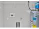 Bright laundry room with shelving, water heater, and utility sink at 110 5Th Sw St, Fort Meade, FL 33841