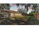 Spacious backyard with a large grassy area and wooden fence at 1555 Archers Path, Lakeland, FL 33809