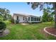 Home with screened patio and beautifully landscaped backyard at 202 Golf Aire Blvd, Winter Haven, FL 33884