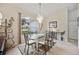 Elegant dining room with a glass-top table and chandelier at 202 Golf Aire Blvd, Winter Haven, FL 33884