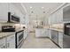 Bright kitchen featuring granite countertops and stainless steel appliances at 202 Golf Aire Blvd, Winter Haven, FL 33884