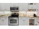 Bright kitchen with granite countertops and stainless steel appliances at 202 Golf Aire Blvd, Winter Haven, FL 33884