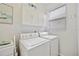 Laundry room with washer, dryer, and overhead cabinets at 202 Golf Aire Blvd, Winter Haven, FL 33884