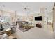 Spacious living area with hardwood floors and a large TV at 202 Golf Aire Blvd, Winter Haven, FL 33884