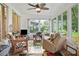 Relaxing sunroom with wicker furniture and view of the backyard at 202 Golf Aire Blvd, Winter Haven, FL 33884