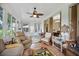 Relaxing sunroom with tiled floor and wicker furniture at 202 Golf Aire Blvd, Winter Haven, FL 33884