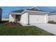 Charming single-story home with attached garage and well-maintained lawn at 2433 Leeds St, Haines City, FL 33844