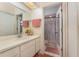 Bathroom with shower and vanity, as well as a decorative mirror and towel rack at 3597 Raintree Ln, Lakeland, FL 33803