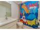 A bathroom featuring tiled walls and a bright, colorful shower curtain at 3597 Raintree Ln, Lakeland, FL 33803