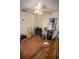 A music-themed bedroom featuring guitars, a ceiling fan, and wood-look flooring at 3597 Raintree Ln, Lakeland, FL 33803
