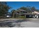 View of home showing modern architectural details, mature trees, and a neighborhood setting at 3597 Raintree Ln, Lakeland, FL 33803