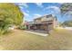 Rear exterior view of house with screened in porch and large backyard at 3597 Raintree Ln, Lakeland, FL 33803