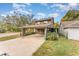 Charming two-story home with a covered carport and well-maintained landscaping at 3597 Raintree Ln, Lakeland, FL 33803