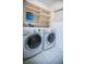 Convenient laundry room with modern washer, dryer and plenty of shelving at 3597 Raintree Ln, Lakeland, FL 33803