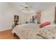 Comfortable main bedroom offers a floral bedspread, ceiling fan, and lots of light at 3597 Raintree Ln, Lakeland, FL 33803