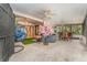 A furnished screened porch with a spa, dining table, and a hanging chair at 3597 Raintree Ln, Lakeland, FL 33803