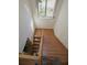 Staircase with hardwood floors and natural light streaming in from the window at 3597 Raintree Ln, Lakeland, FL 33803