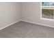 A carpeted bedroom with a window with an outside view at 428 Ituna Cir, Winter Haven, FL 33881