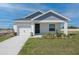 Charming single-Gathering home featuring a tidy lawn, a single-car garage, and a welcoming front porch at 428 Ituna Cir, Winter Haven, FL 33881