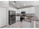 Modern kitchen featuring stainless steel appliances, granite countertops, and white cabinets at 428 Ituna Cir, Winter Haven, FL 33881