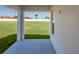 An empty covered porch with a view of green land at 428 Ituna Cir, Winter Haven, FL 33881