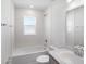 Clean bathroom featuring a shower-tub combo, white tile, and natural light at 468 Ituna Cir, Winter Haven, FL 33881
