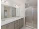Bathroom featuring double sink vanity with a glass-enclosed shower at 468 Ituna Cir, Winter Haven, FL 33881