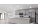 Bright, open kitchen boasts stainless steel appliances and an island at 468 Ituna Cir, Winter Haven, FL 33881
