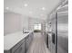 Modern kitchen featuring stainless steel appliances, gray cabinets, and an island at 468 Ituna Cir, Winter Haven, FL 33881