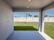 Covered patio with a view of the green backyard and privacy fence at 468 Ituna Cir, Winter Haven, FL 33881