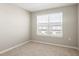 Bright bedroom with carpeted floor and large window at 5742 Anders Way, St Cloud, FL 34771