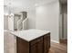 Kitchen island with quartz countertop and dark brown cabinets at 5742 Anders Way, St Cloud, FL 34771