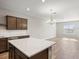 Open concept kitchen with island, stainless steel appliances, and hardwood floors at 5742 Anders Way, St Cloud, FL 34771