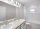 Well-lit bathroom with double sink vanity and tiled shower/tub combination at 596 Ituna Cir, Winter Haven, FL 33881