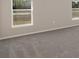 Comfortable bedroom featuring neutral colored walls, plush carpeting, and ample natural light at 596 Ituna Cir, Winter Haven, FL 33881