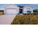 Charming single-story home with a well-manicured lawn and attached two-car garage at 596 Ituna Cir, Winter Haven, FL 33881
