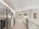 Bright open kitchen featuring stainless steel appliances, white cabinets, and large island at 596 Ituna Cir, Winter Haven, FL 33881