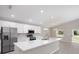 Eat-in kitchen with stainless steel appliances, island with sink, and laminate flooring at 596 Ituna Cir, Winter Haven, FL 33881