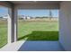 Covered porch overlooking a spacious backyard with a view of the surrounding neighborhood at 720 Bayside Blvd, Winter Haven, FL 33881