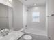 Bright bathroom featuring a tub/shower combo, white cabinets, and tile flooring at 720 Bayside Blvd, Winter Haven, FL 33881
