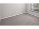 Cozy bedroom featuring plush carpeting and a bright window for natural light at 720 Bayside Blvd, Winter Haven, FL 33881