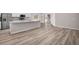 Open-concept kitchen featuring an island, stainless steel appliances, and wood flooring at 720 Bayside Blvd, Winter Haven, FL 33881