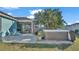 Private backyard featuring a relaxing hot tub, screened-in patio, and lush tropical landscaping for serene outdoor living at 7525 Jessamine Dr, Lakeland, FL 33810