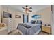 Cozy bedroom featuring a ceiling fan, dresser, and calming blue accents at 7525 Jessamine Dr, Lakeland, FL 33810