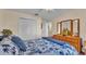 Inviting bedroom with a ceiling fan, closet, and dresser near the bed at 7525 Jessamine Dr, Lakeland, FL 33810