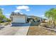 Charming single-story home with a well-manicured lawn, mature palm trees, and a two-car garage on a sunny day at 7525 Jessamine Dr, Lakeland, FL 33810