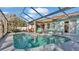 Inviting in-ground swimming pool with screened enclosure, patio seating, and ample space for outdoor entertaining at 7525 Jessamine Dr, Lakeland, FL 33810