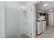 A bathroom featuring a frosted glass shower door and a laundry area with washer and dryer at 1323 Valley E Hl, Lakeland, FL 33813