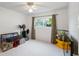 This comfortable carpeted bedroom gets plenty of light and has a ceiling fan at 1323 Valley E Hl, Lakeland, FL 33813